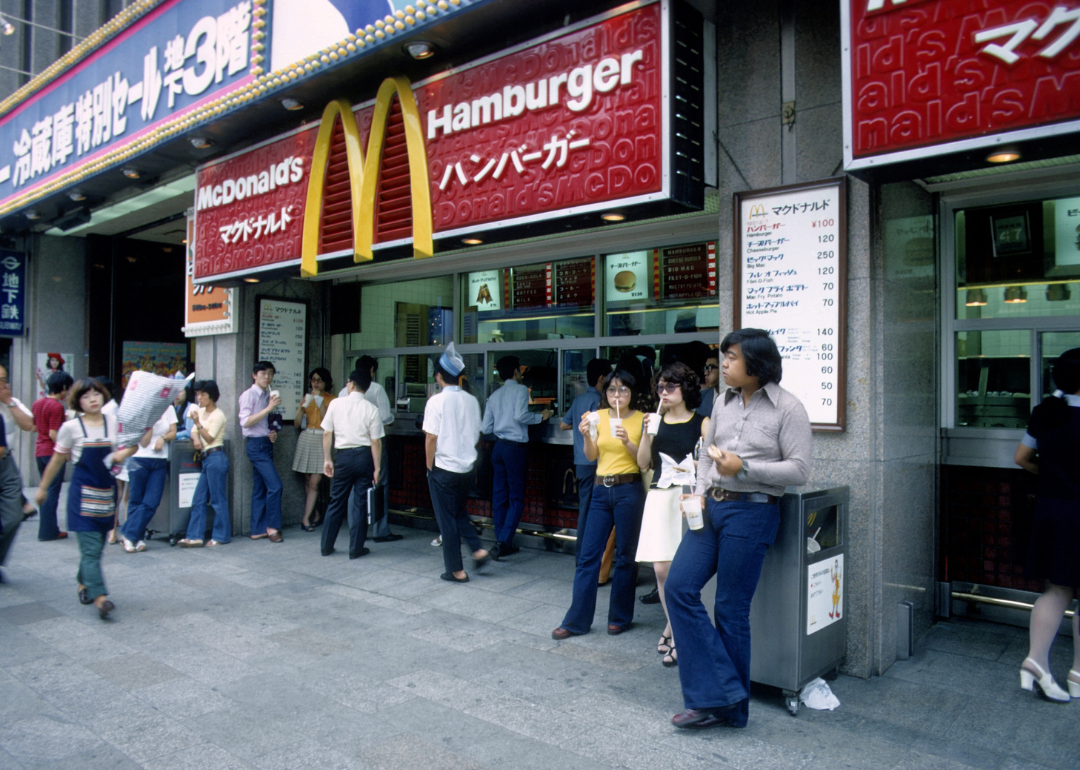 People stand at the entrance to McDonald's restaurant in Japan.