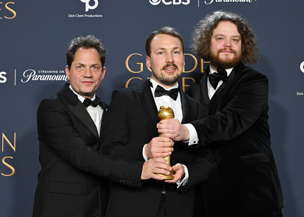 Ron Dyens, Gints Zilbalodis, Matiss Kaza pose with Golden Globe award for Best Motion Picture - Animated.