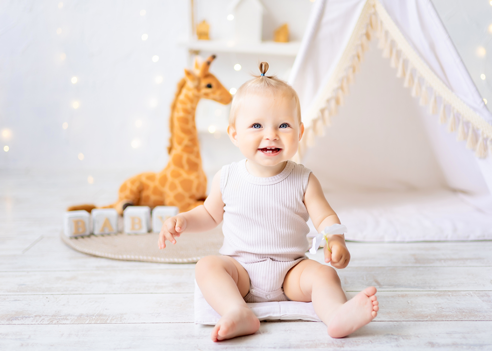 Happy baby in nursery.