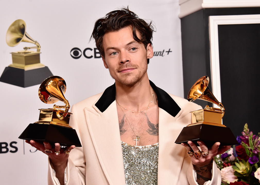 Harry Styles poses with Grammy Awards.