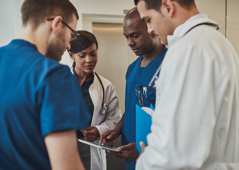 Group of medical professionals reviewing tablet