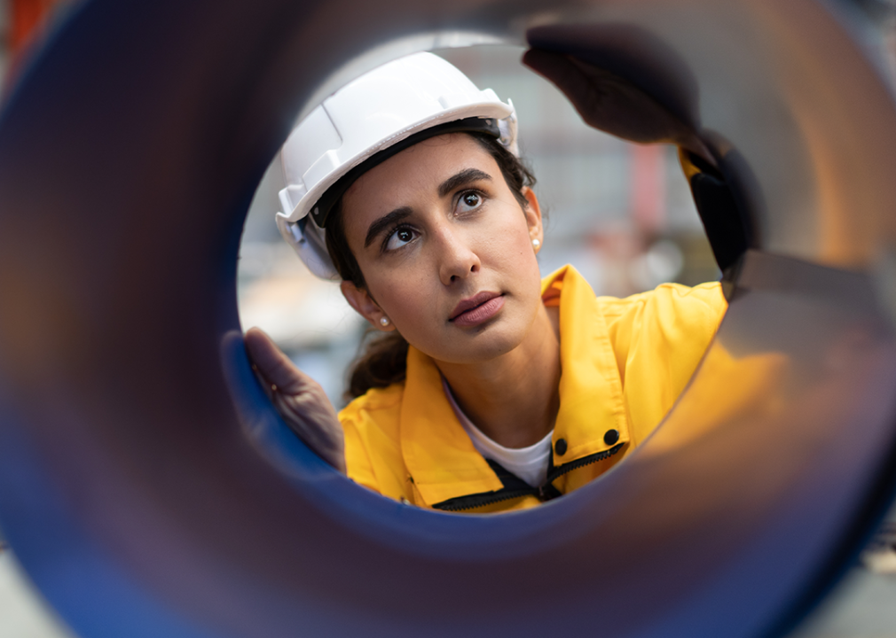 Industrial engineer wearing safety helmet in factory.