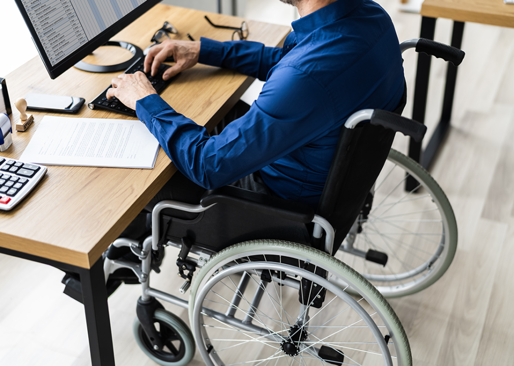 Person in wheelchair working at desk.