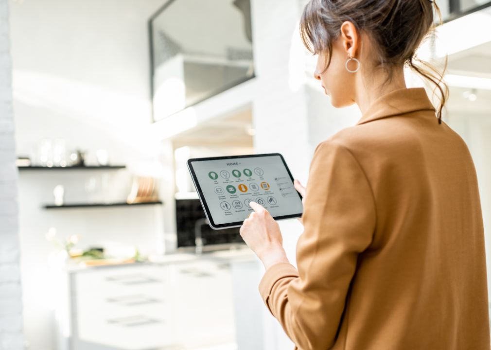Woman with tablet managing smart home devices
