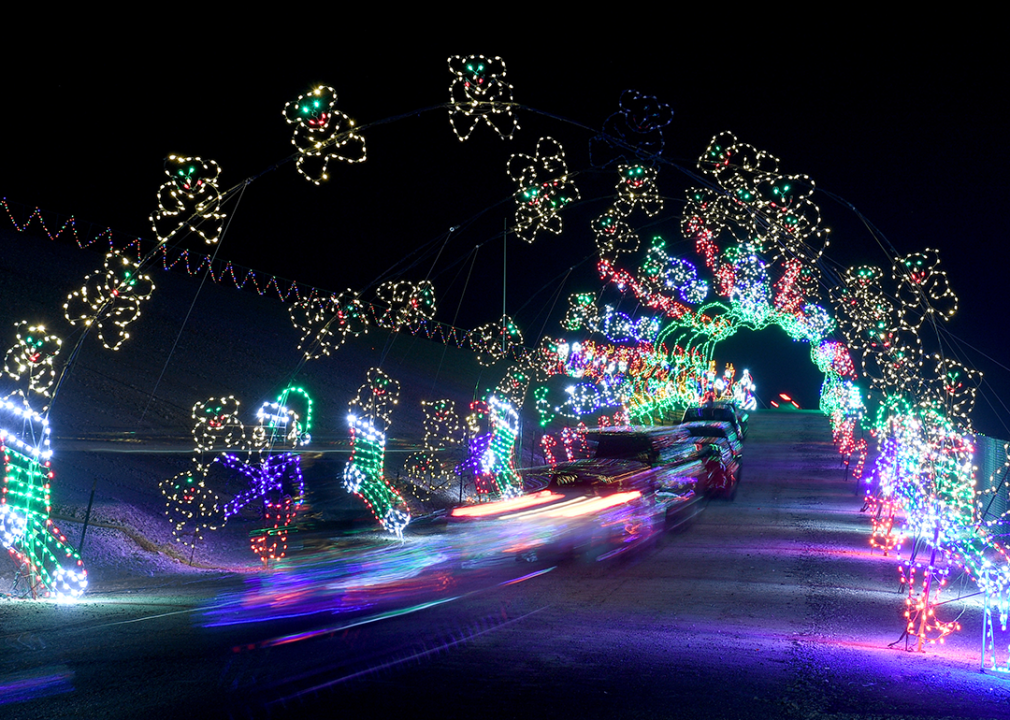 Vehicles travel through a tunnel of lights.