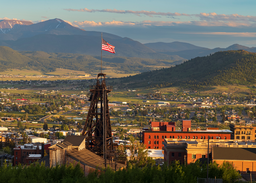 A mine head frame with flag against the Butte, Montana skyline.