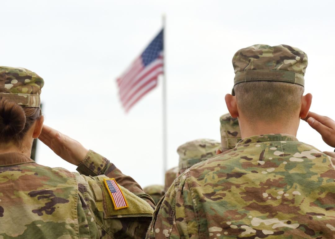 American Soldiers saluting flag.