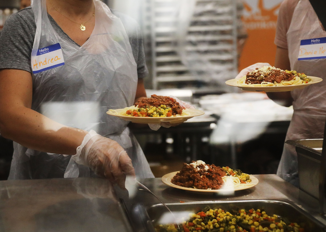 Volunteers serve an evening meal at community kitchen