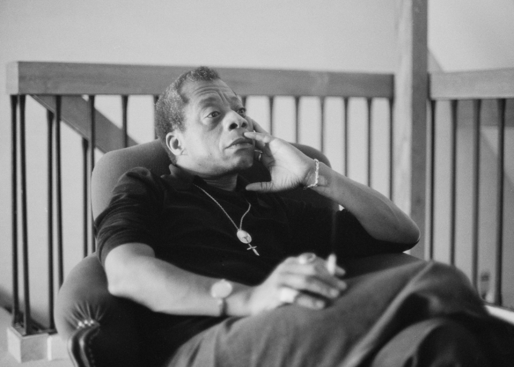 Portrait of James Baldwin seated.