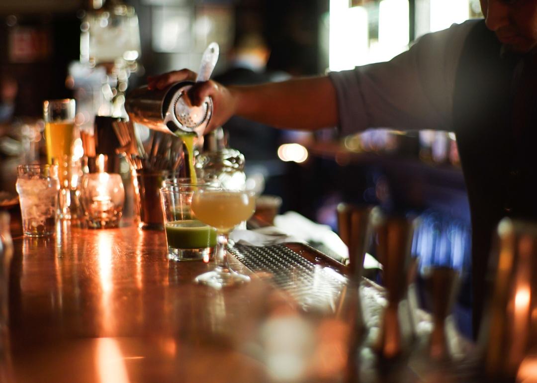 Bartender pouring drinks in bar
