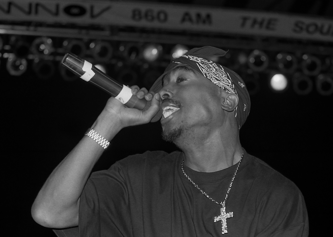 Tupac Shakur performs onstage.