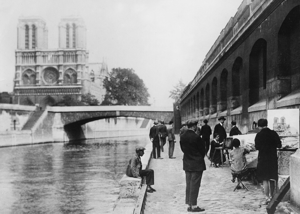 Painters at the river Seine and cathedral Notre Dame.