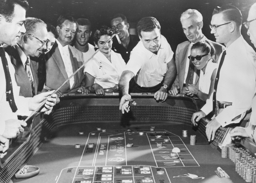 People playing craps game in casino.