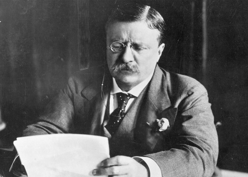 Theodore Roosevelt at desk.