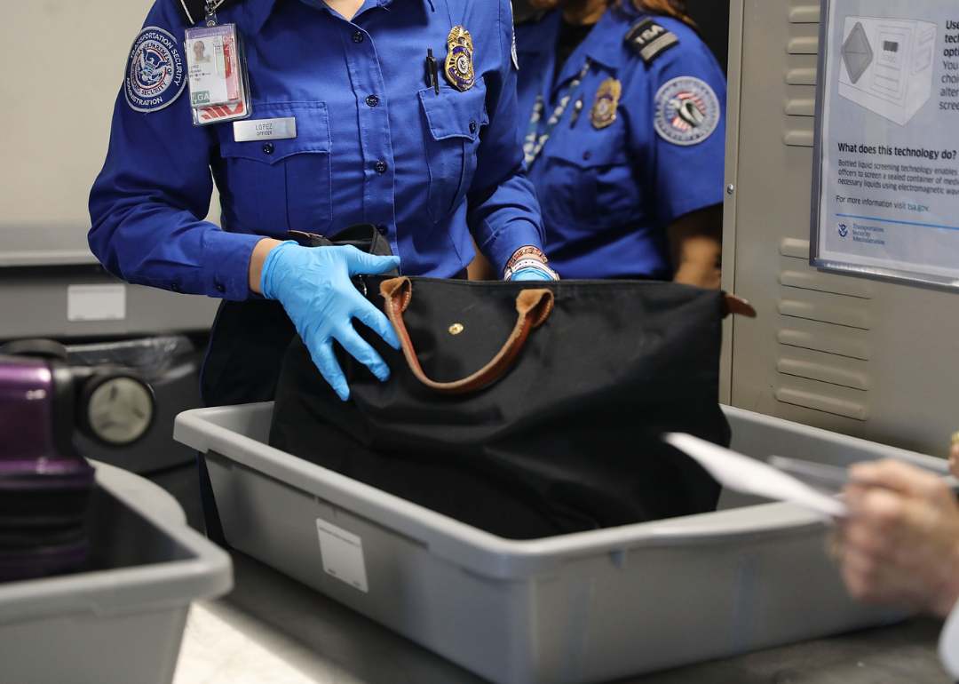 Transportation Security Administration officer inspects a bag.