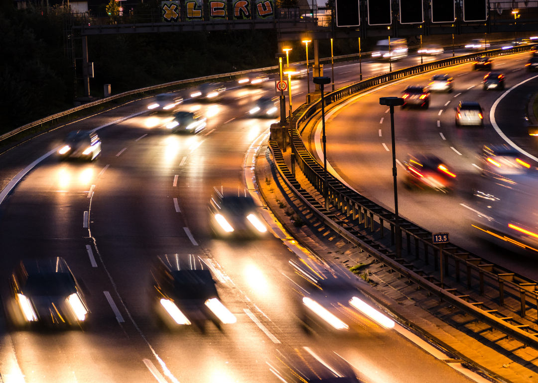 Blurred cars in motion on highway at night.