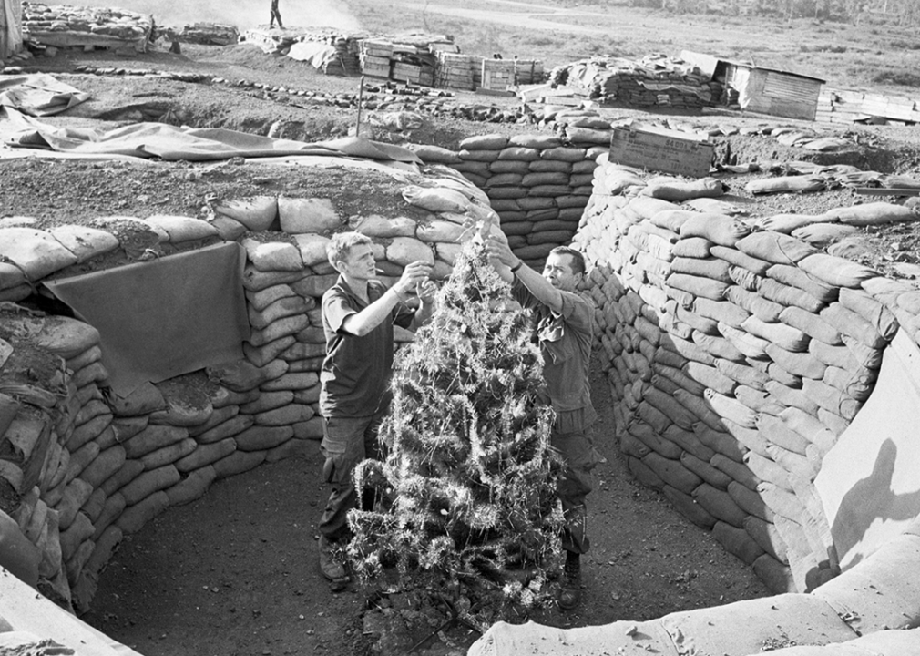 Soldiers in Vietnam with a Christmas tree in mortar pit.