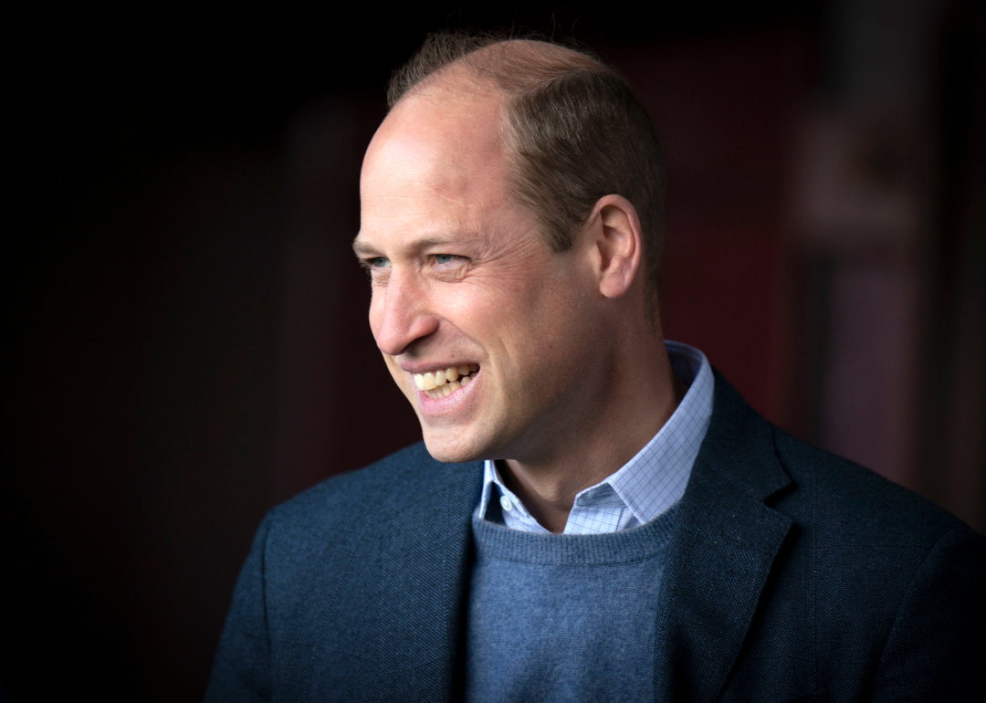 Prince William smiling at event.