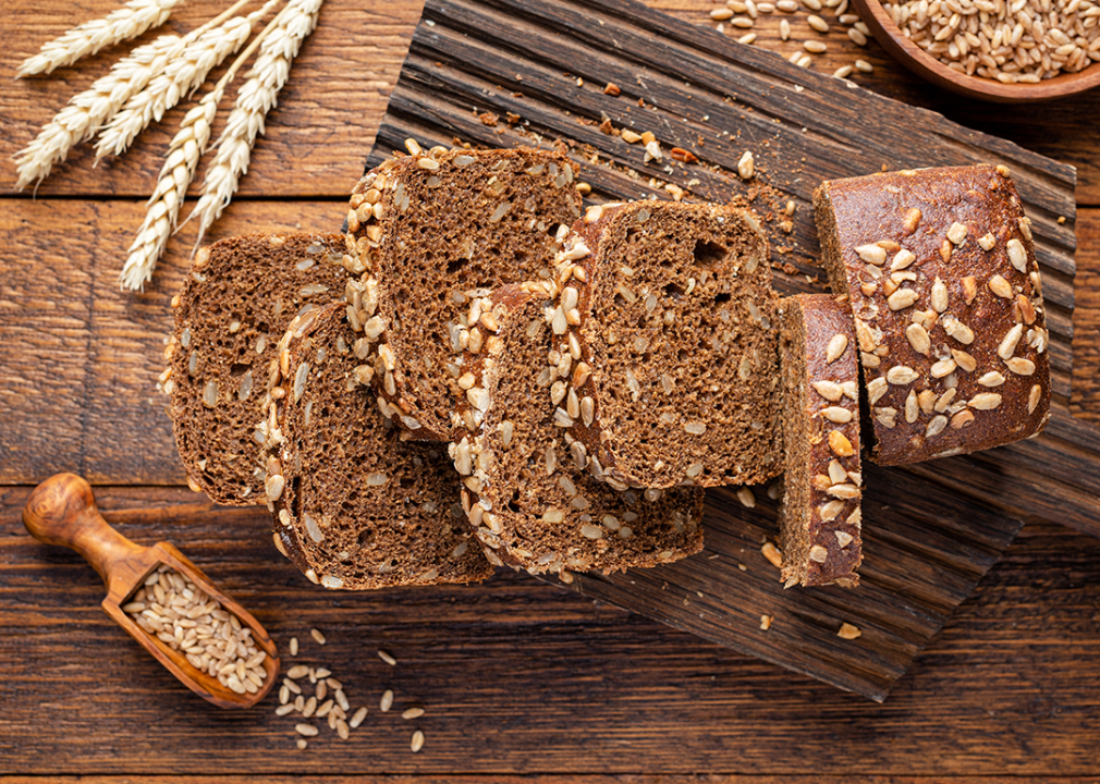 Whole grain rye bread on wooden board.