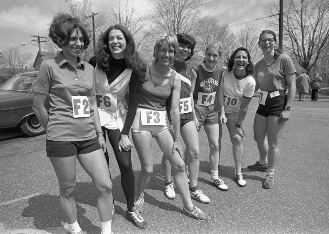 A group of women pose for a photo before running the Boston Marathon.