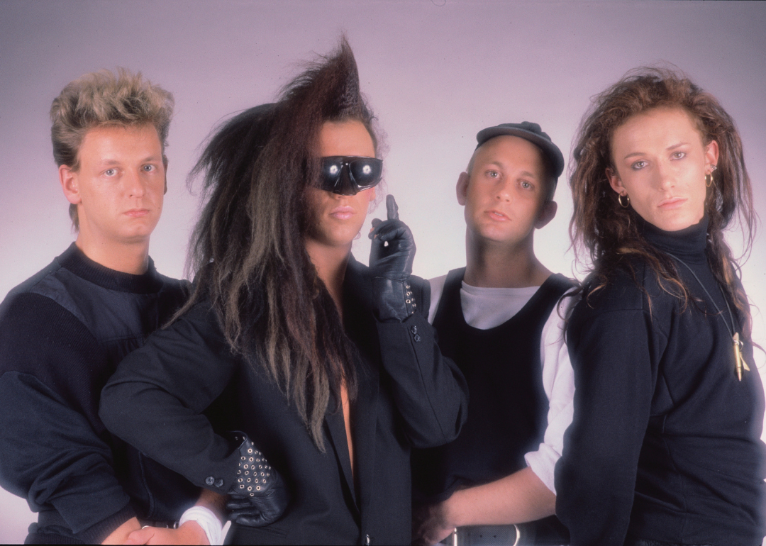 The band Dead or Alive pose for a studio portrait.