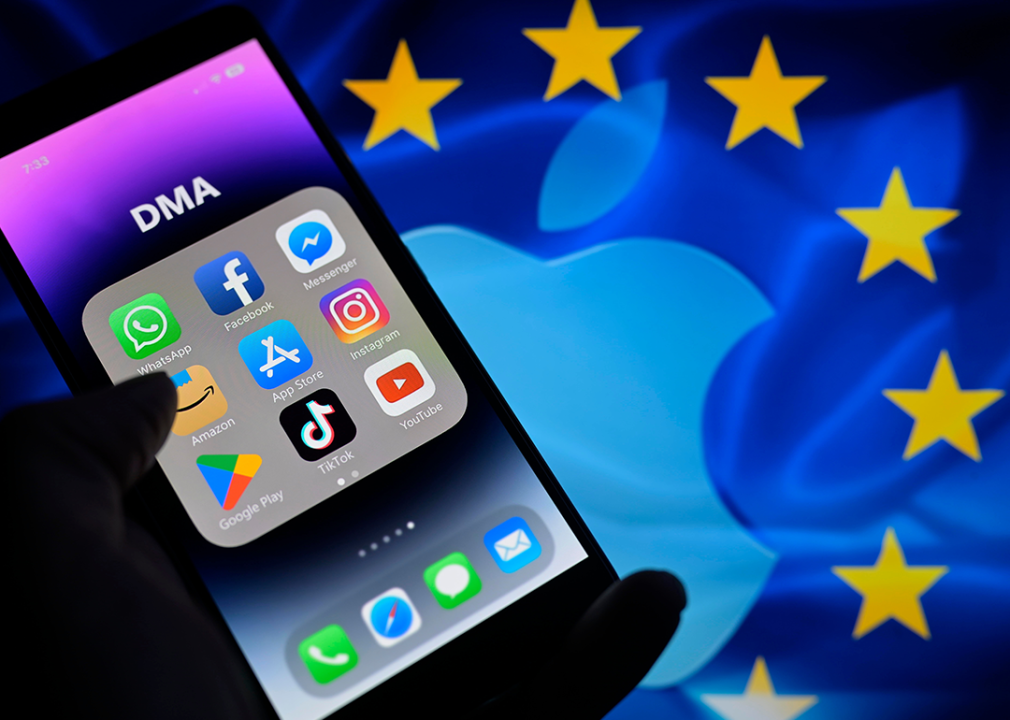 EU flag and Apple logo with smartphone home screen.