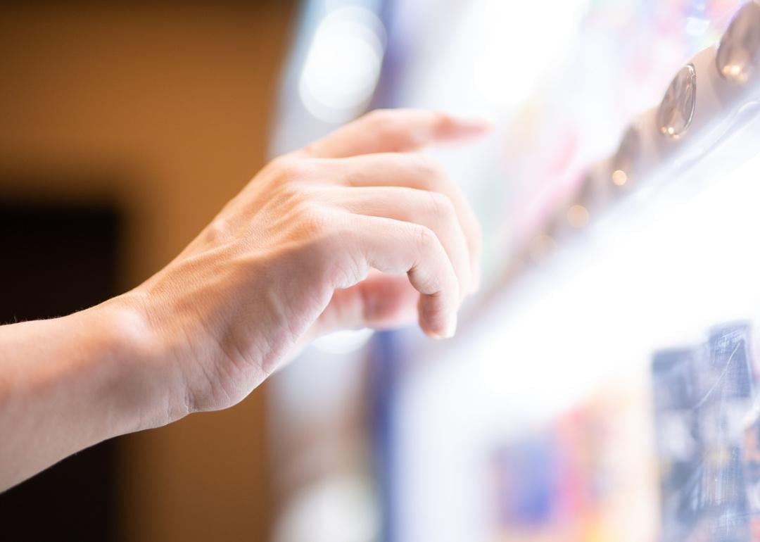 Customer selecting item in vending machine.