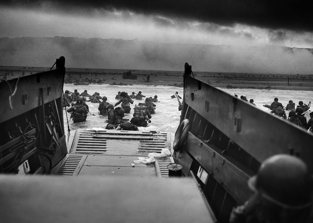 US Troops wading through water after reaching Normandy and landing Omaha beach on D Day.