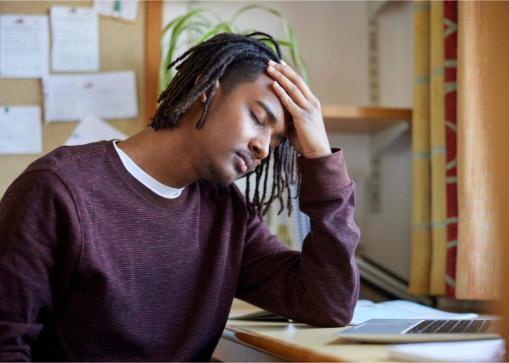 Overwhelmed male university student at computer