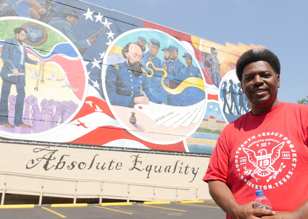 President of the Juneteenth Legacy Project Sam Collins poses in front of “Absolute Equality” mural.
