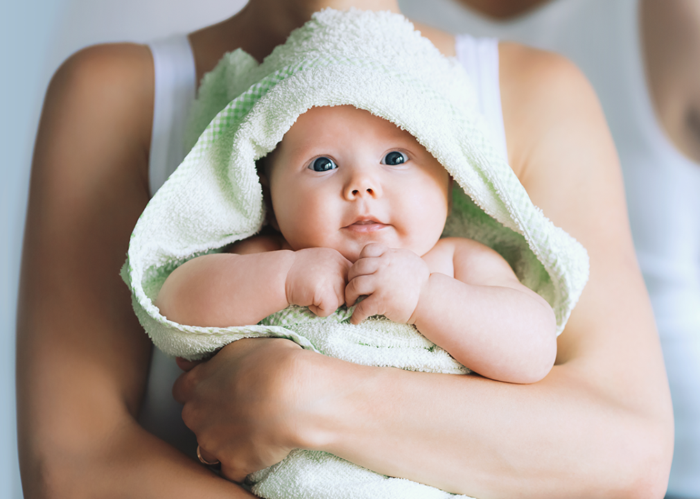 Mother holding baby after bath.