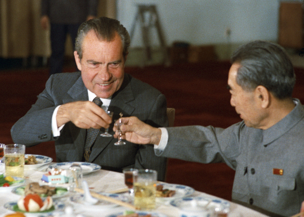 Premier Zhou Enlai and President Richard Nixon toast each other.