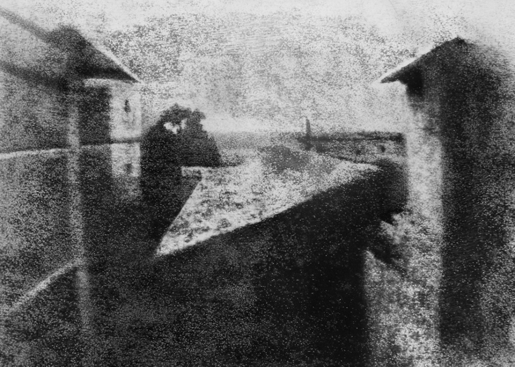 Grainy black-and-white image of rooftops.