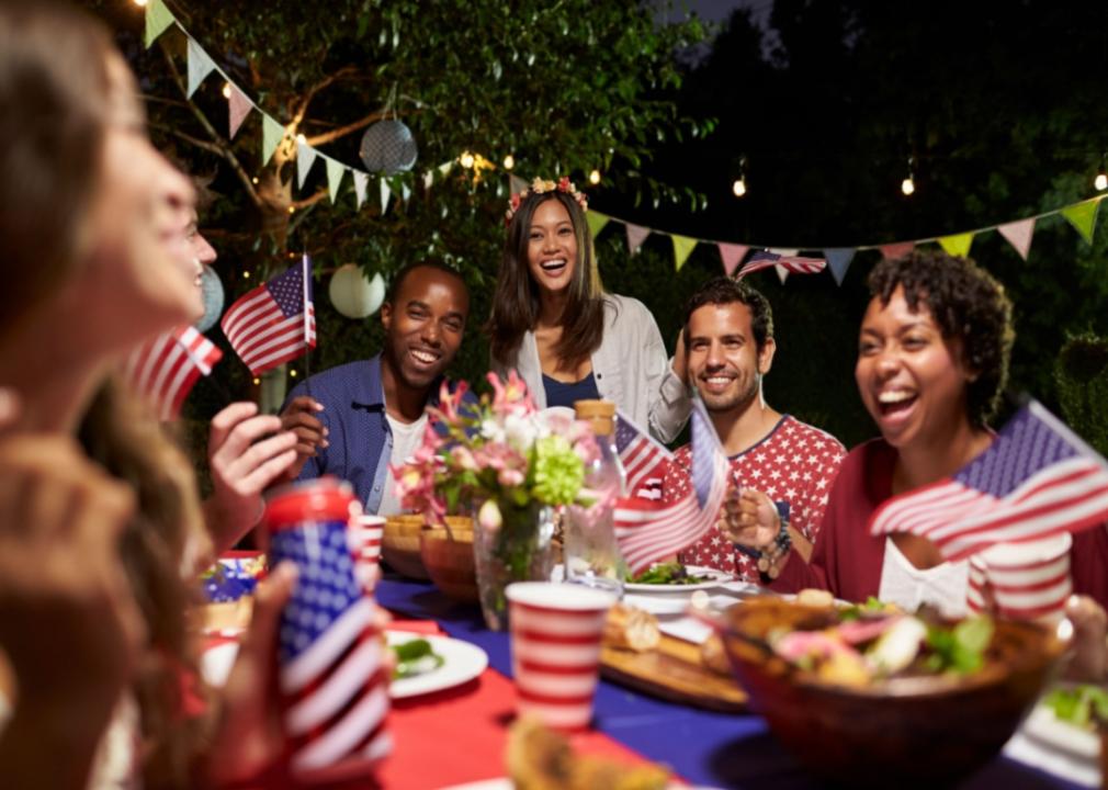 People with patriotic decor having dinner outside.