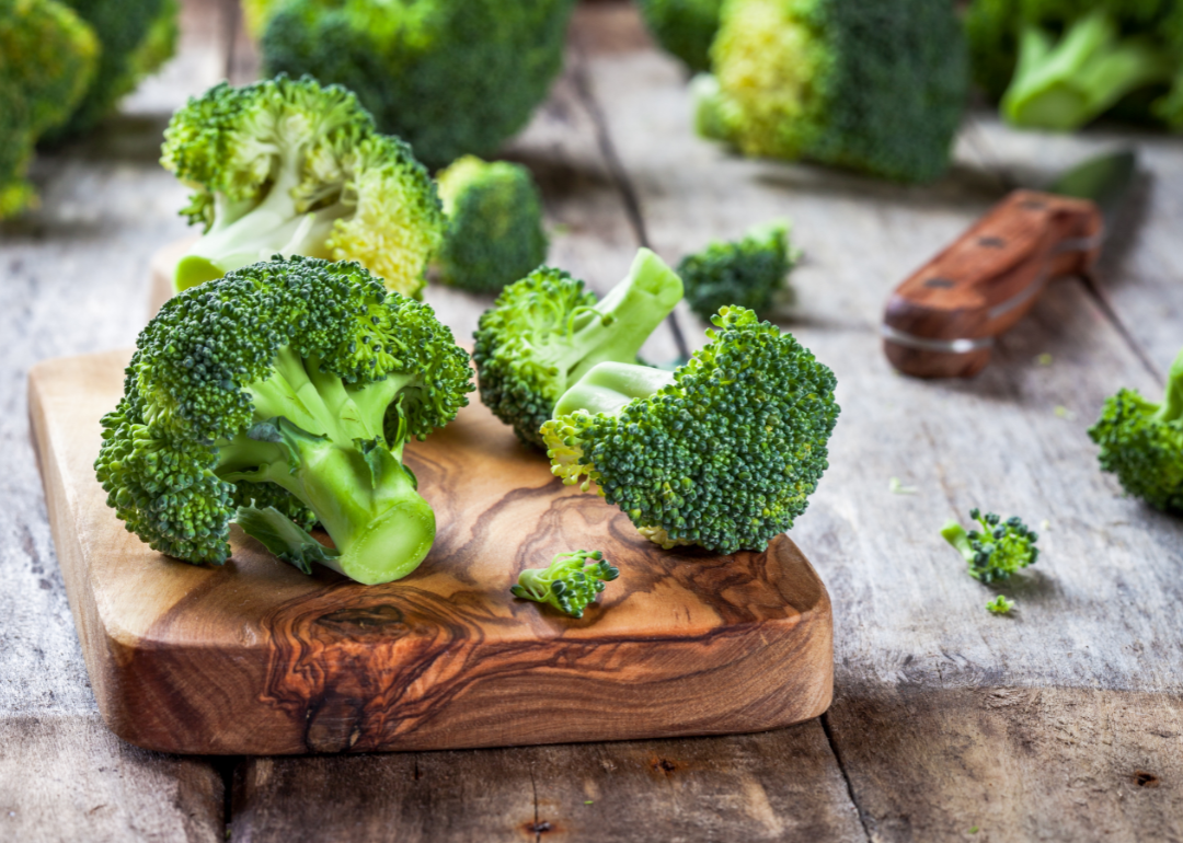 Fresh organic broccoli on cutting board.