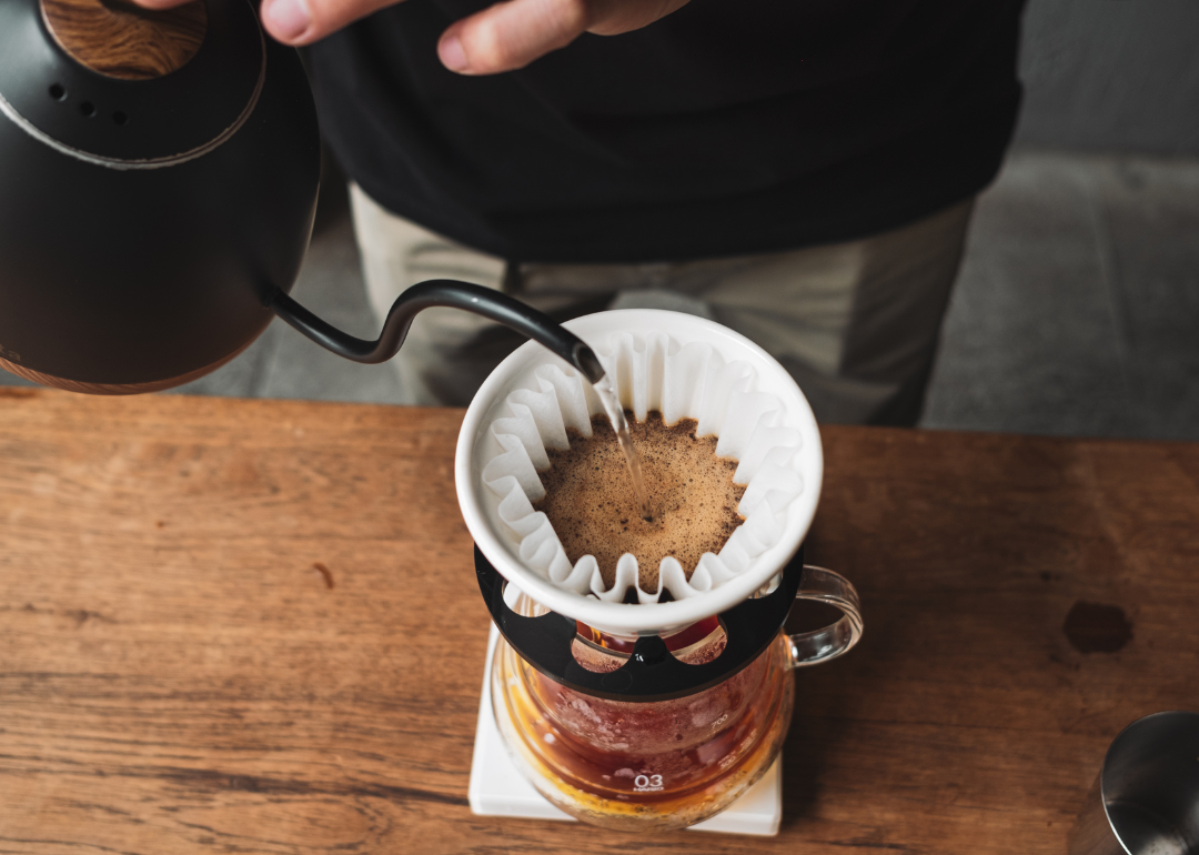 Person preparing drip coffee.