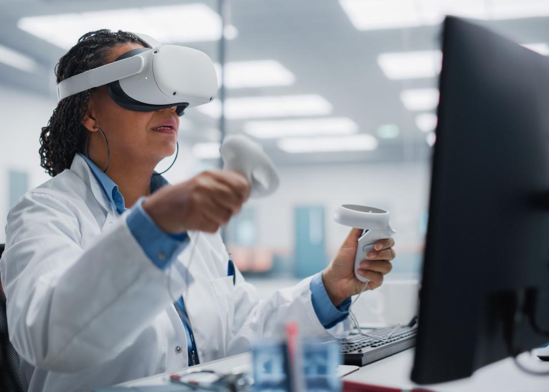 A female neurosurgeon wearing a virtual reality headset uses a controller