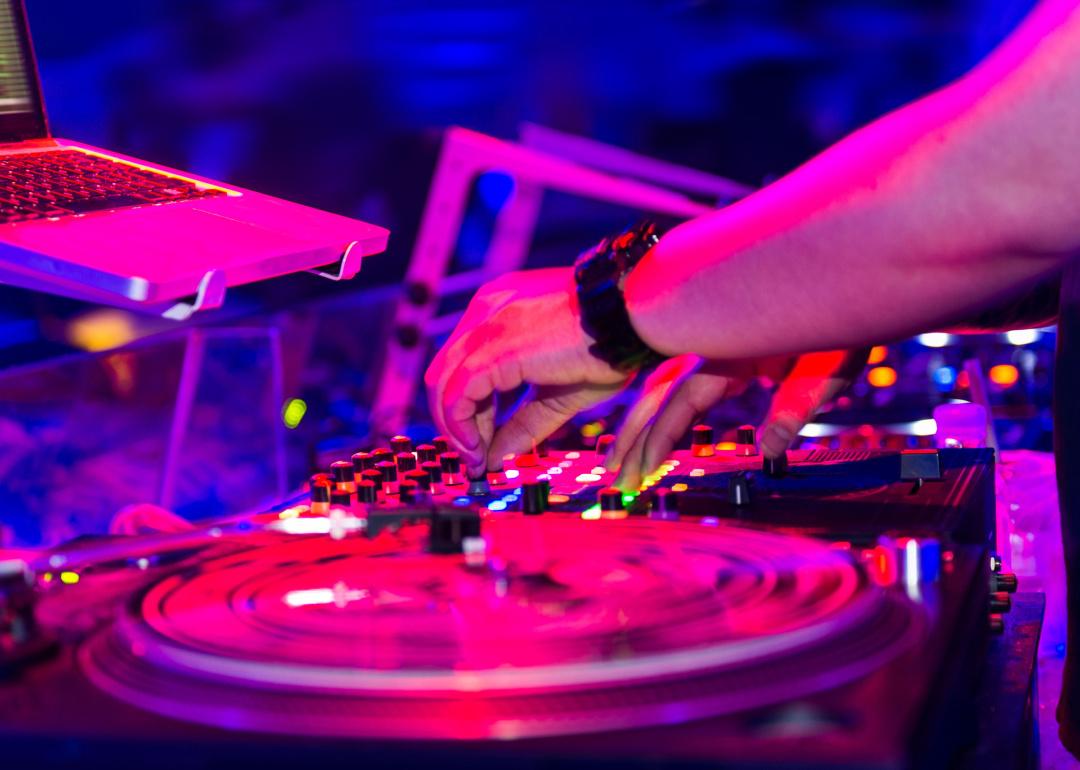 DJ mixing in nightclub.