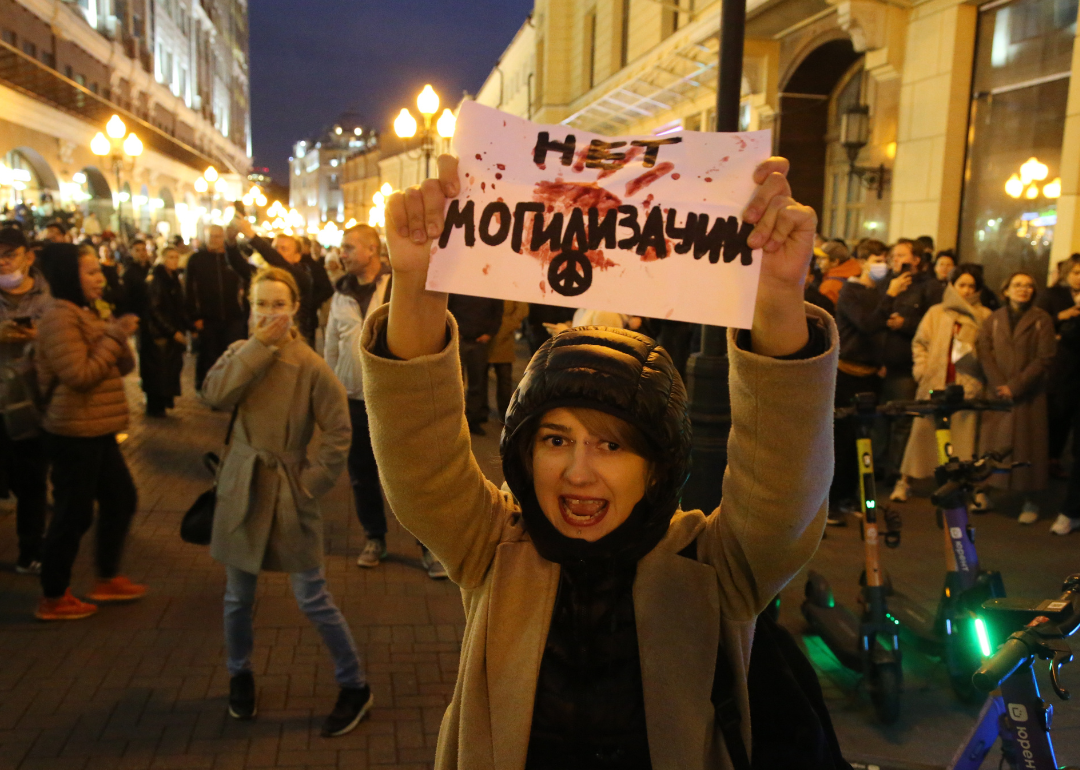 A female activist holding anti-mobilization poster at unsanctioned protest rally in Moscow.