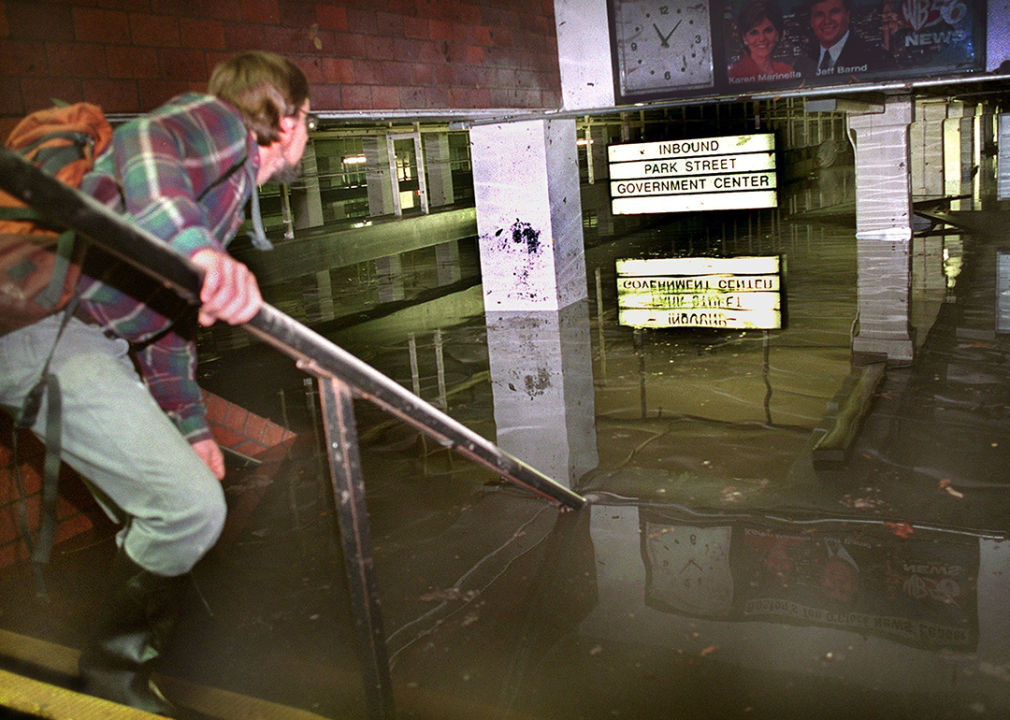Person on the steps of the submerged Kenmore Square MBTA station.
