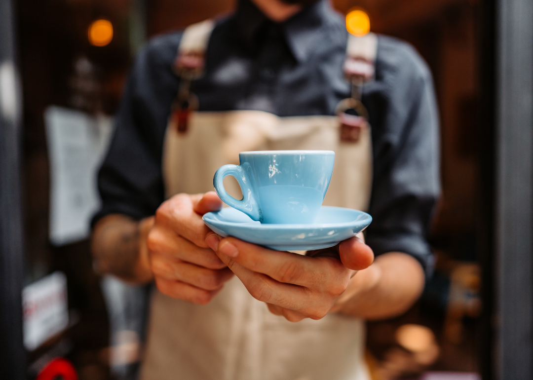 Barista serving coffee.