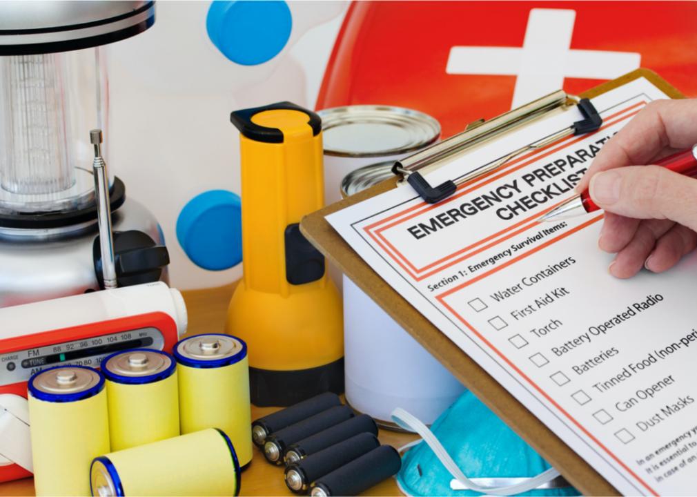 Image shows a close-up of a hand checking items off an emergency checklist