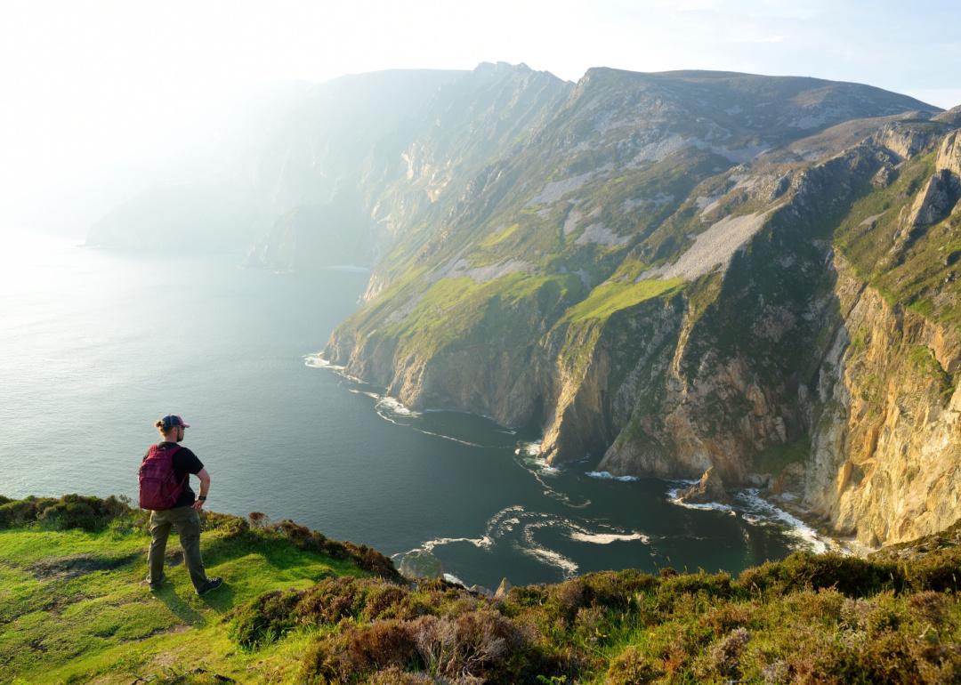Traveler taking in view of Slieve League, the highest sea cliffs in Ireland