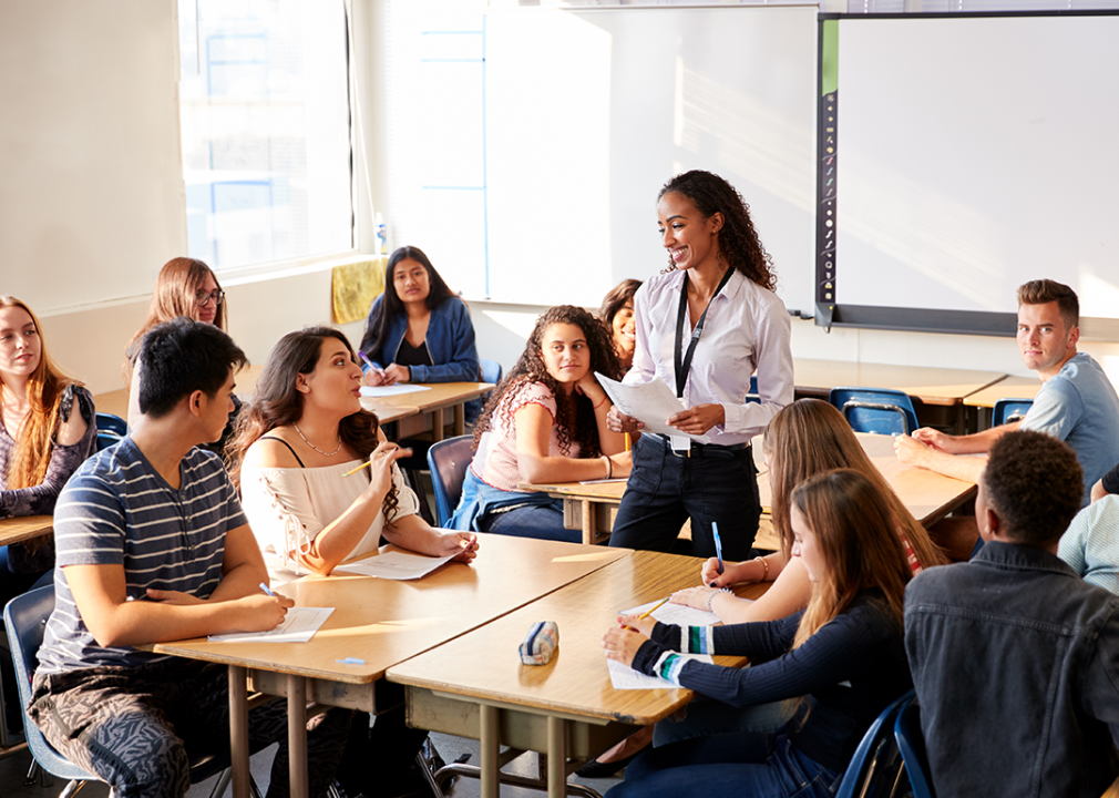 Teacher instructing students in a classroom.