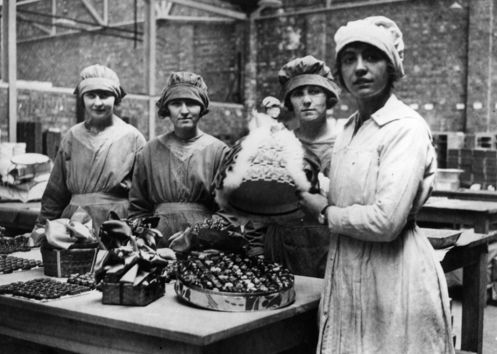 Workers packing up chocolates for Christmas in a confectionery factory.