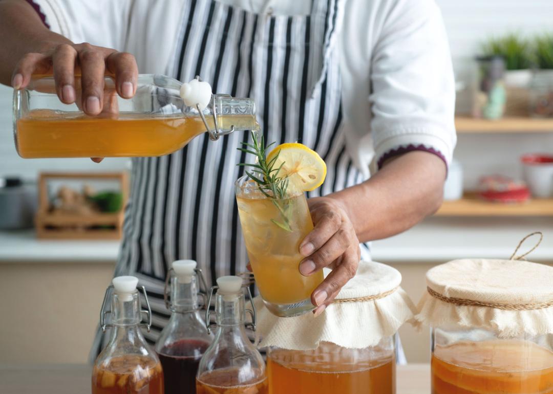 Person preparing kombucha drinks.