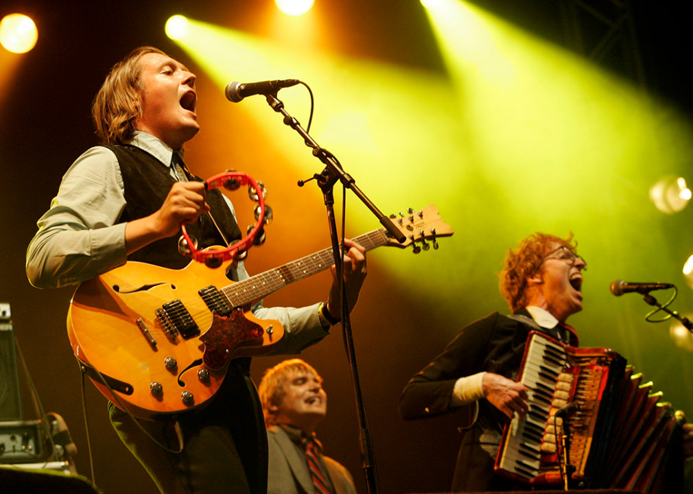 Arcade Fire’s Win Butler, Tim Kingsbury and Richard Reed Parry performing onstage.