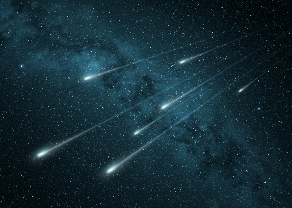 Illustration of meteor shower in night sky.