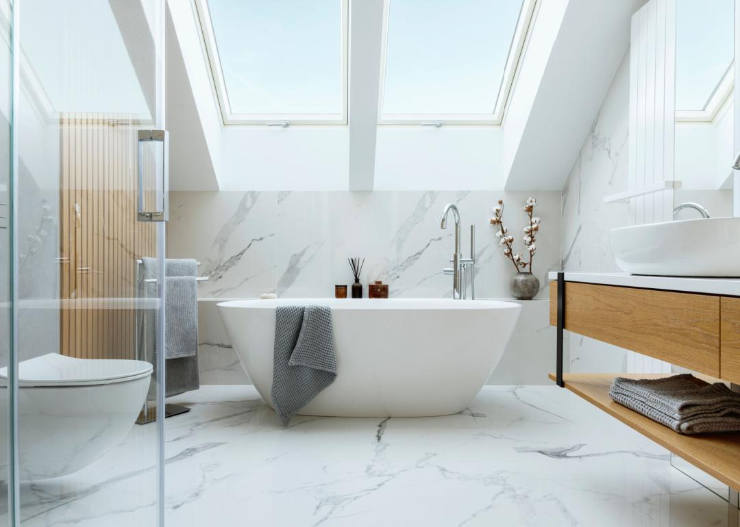 Modern white bathroom with marble walls.