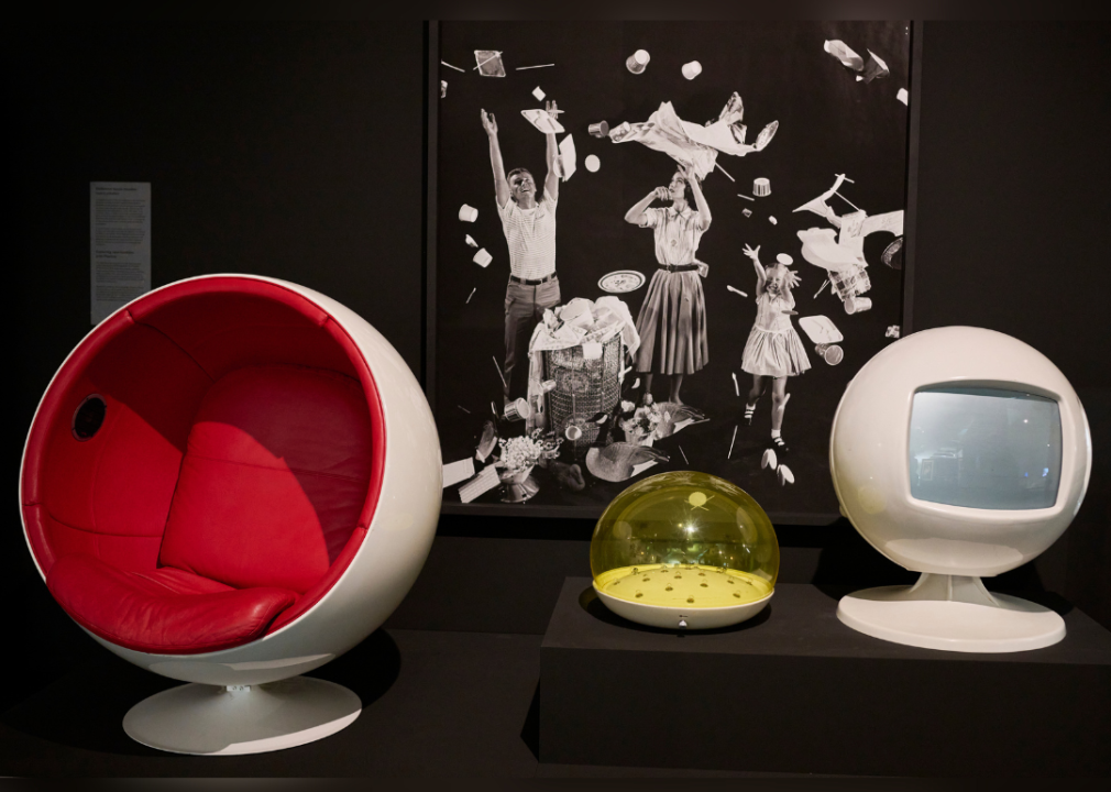 Ball chair and moon lamp displayed in a museum exhibition.